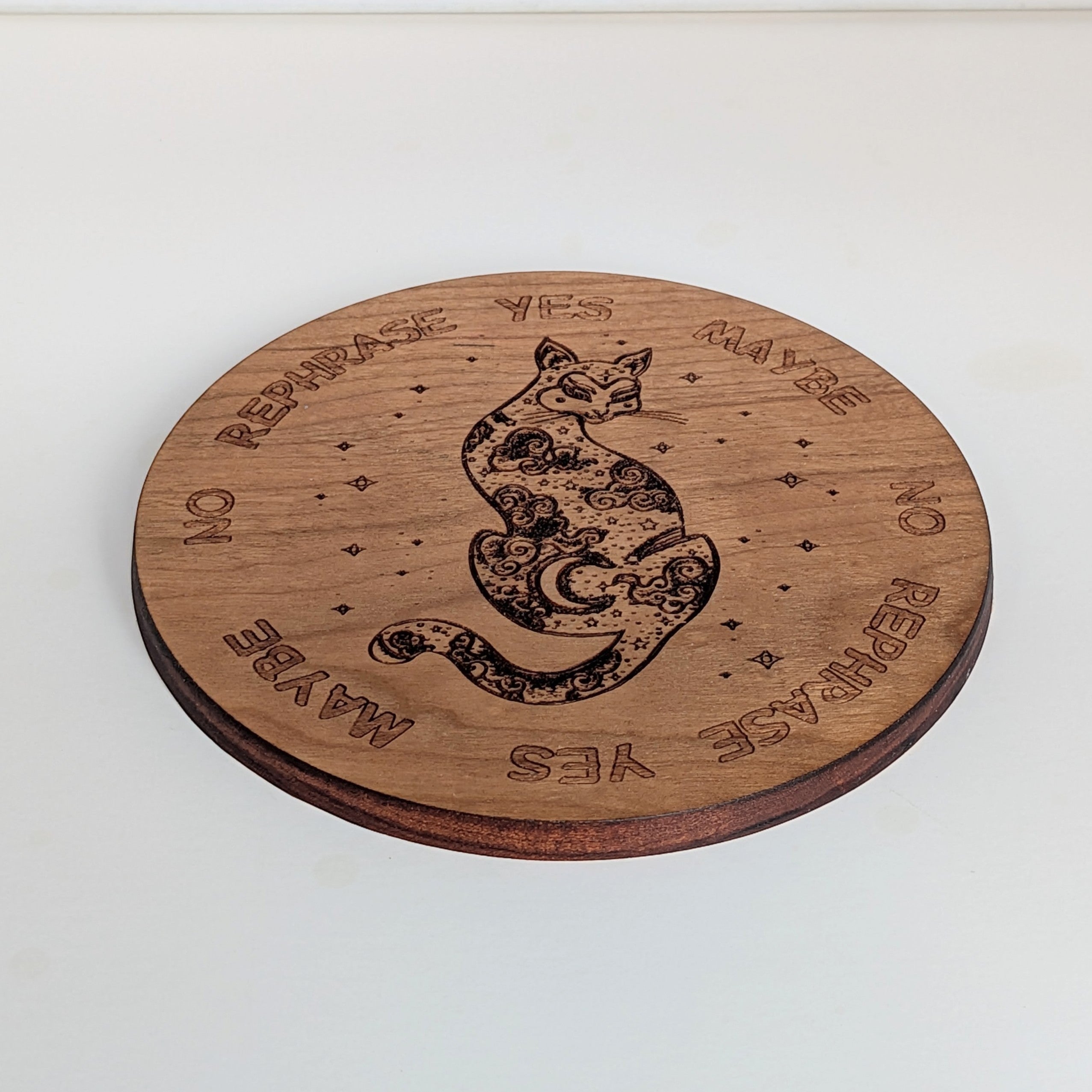 Dogman's Designs wooden pendulum board with a celestial cat design and YES, NO, MAYBE, REPHRASE text.