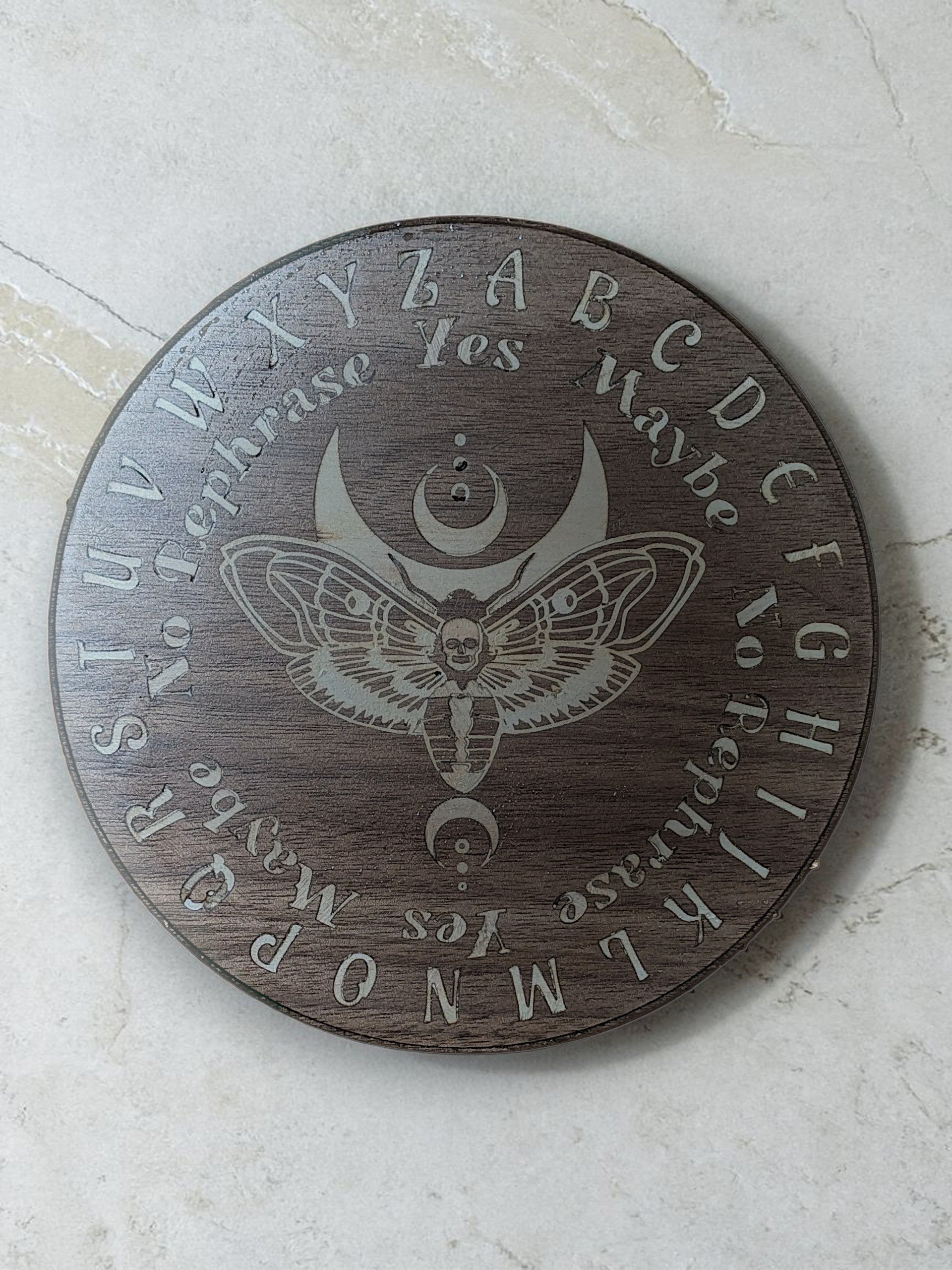 Dogman's Designs wooden pendulum board with moth and moon design, featuring alphabet, yes, no, and maybe.