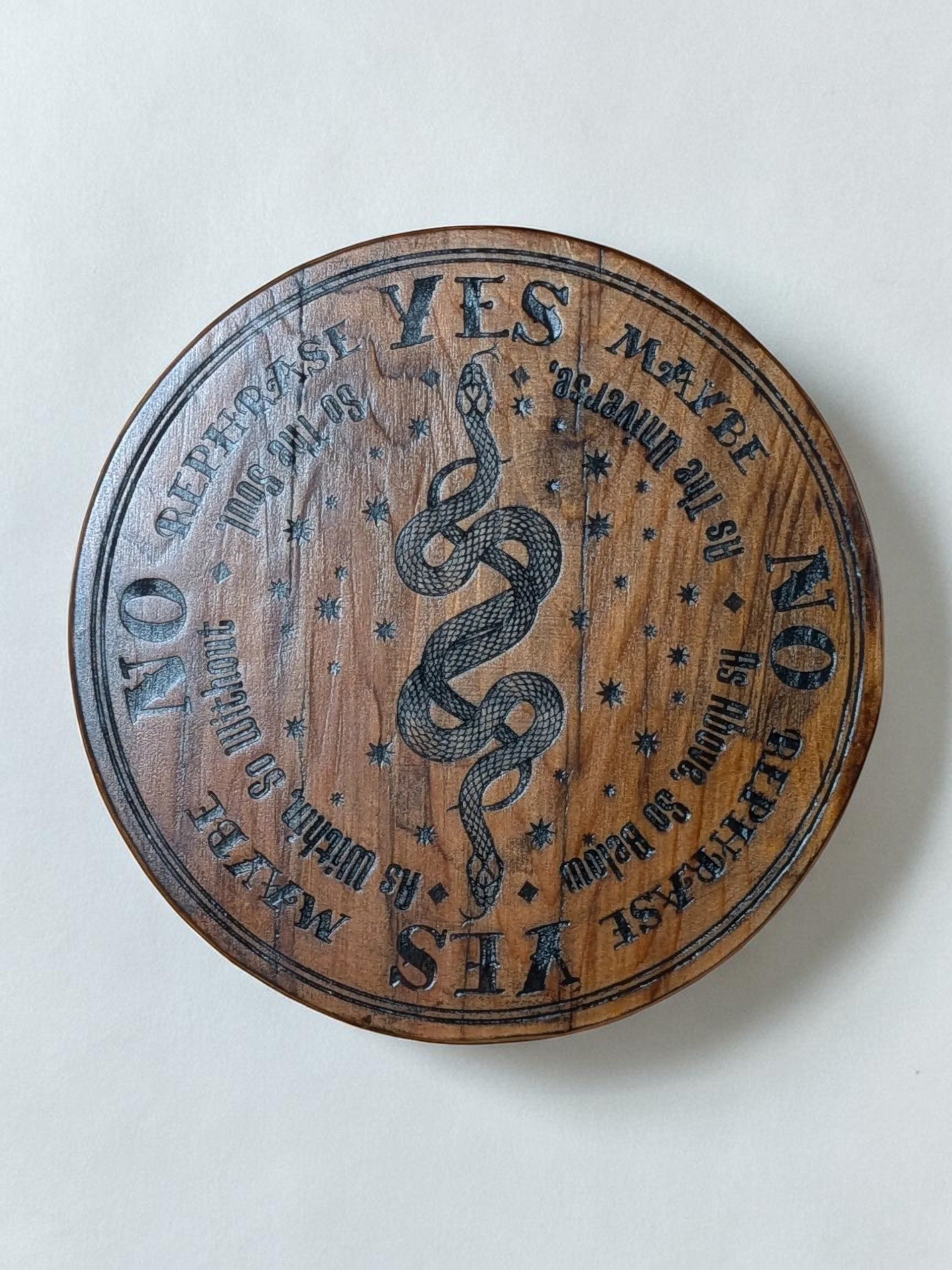 Dogman's Designs wooden pendulum board with snake design, featuring YES, NO, MAYBE, REPHRASE, and celestial star accents.