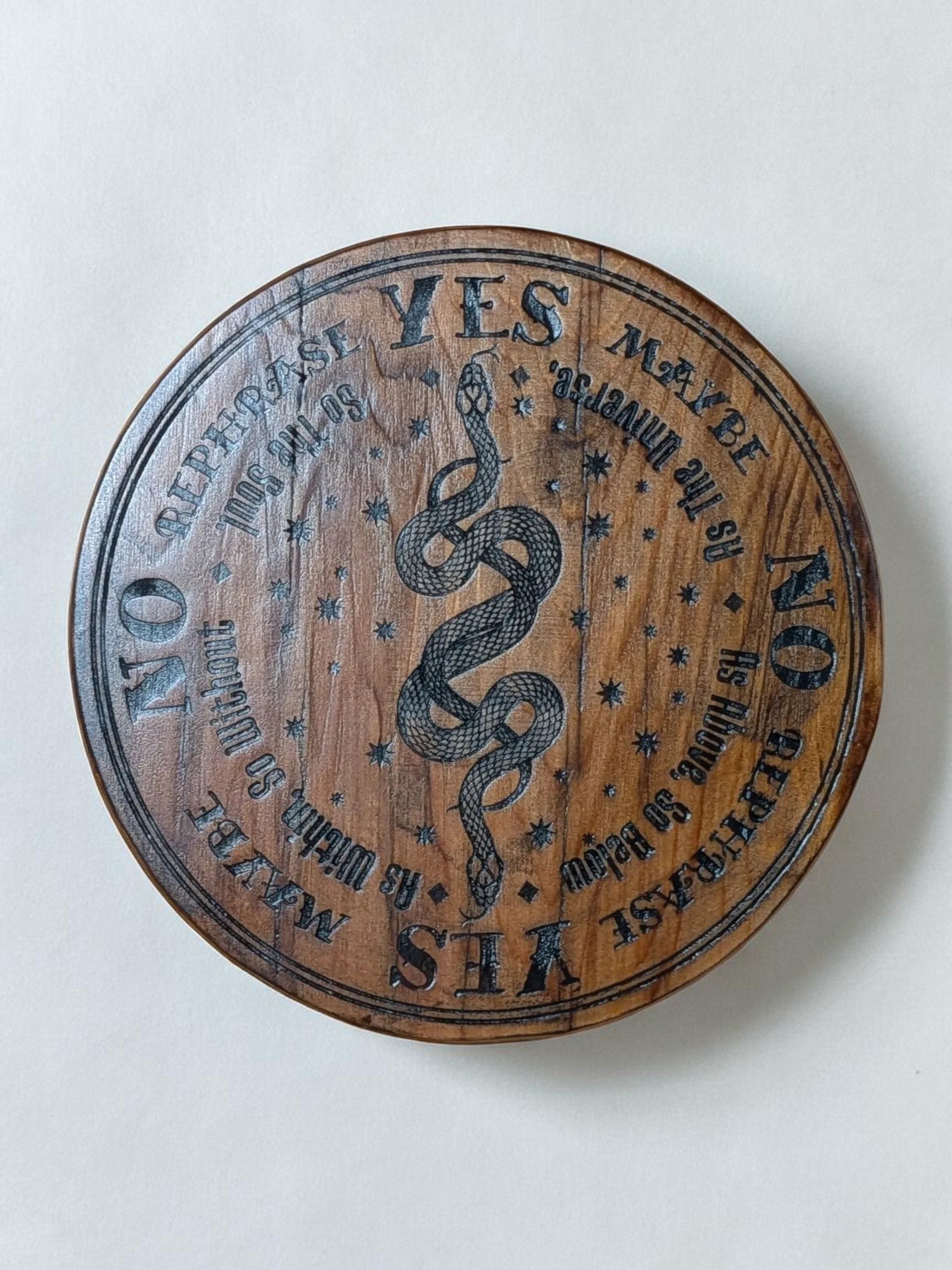 Dogman's Designs wooden pendulum board with YES, NO, MAYBE, and REPHRASE options, featuring a snake and stars.